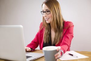 working woman, table, and laptop